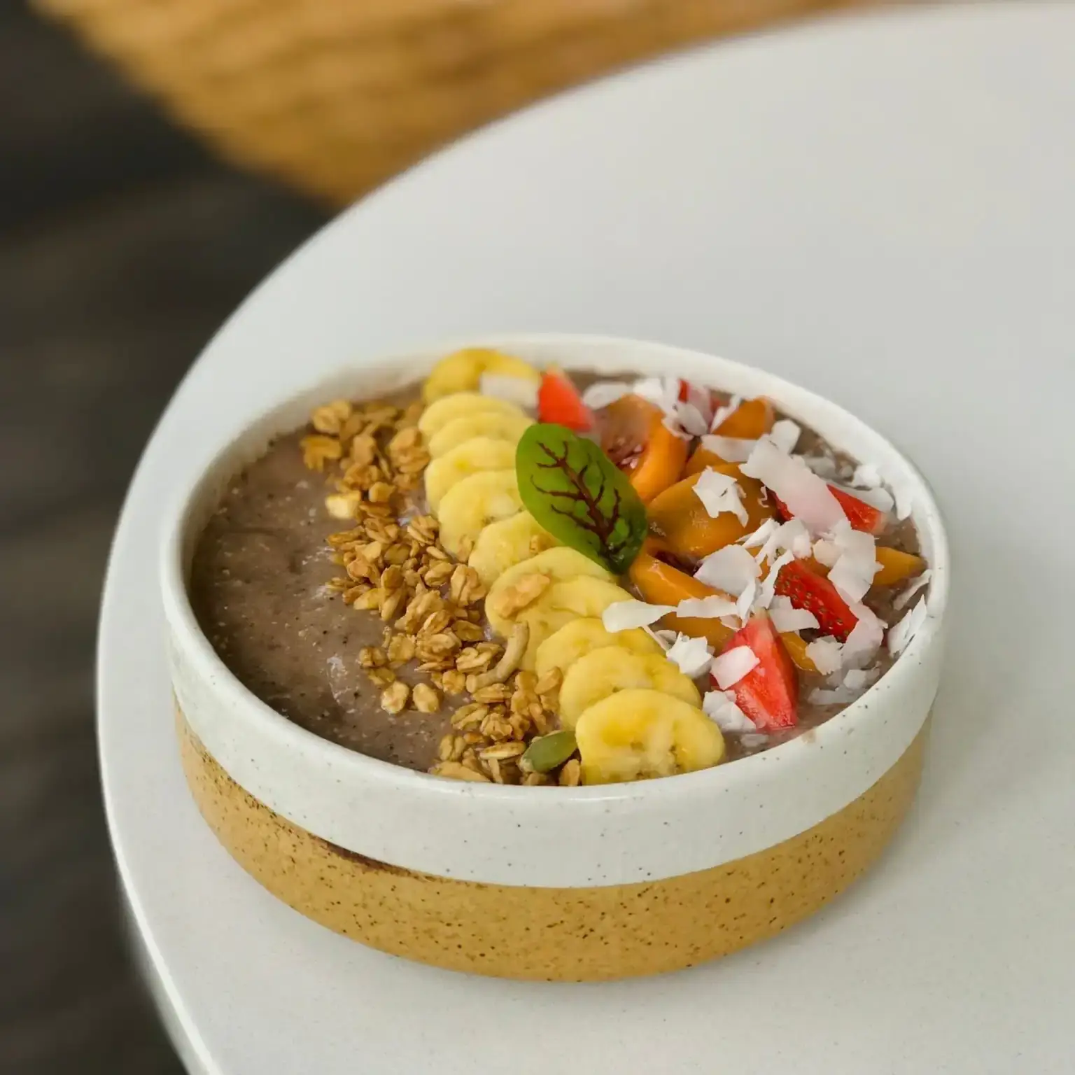 Smoothie bowl dengan pisang, granola, dan beri