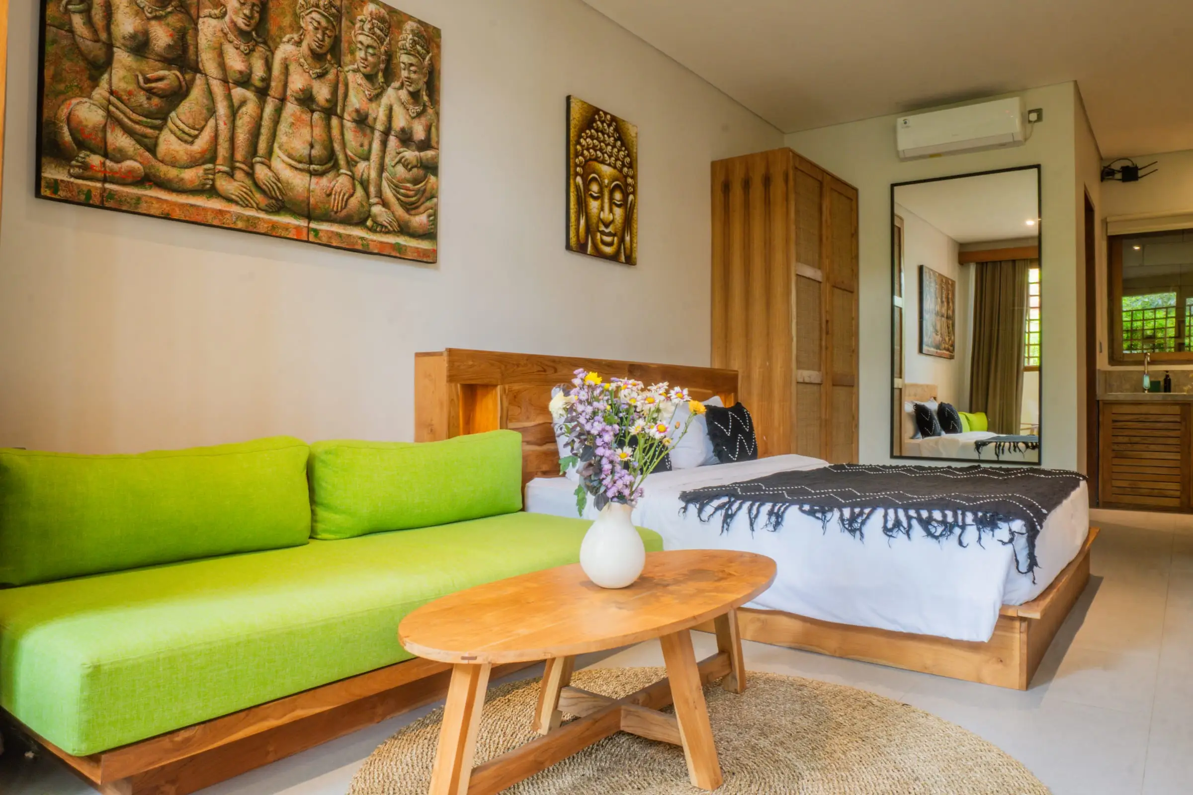 Kamar dengan sofa hijau dan ukiran dinding